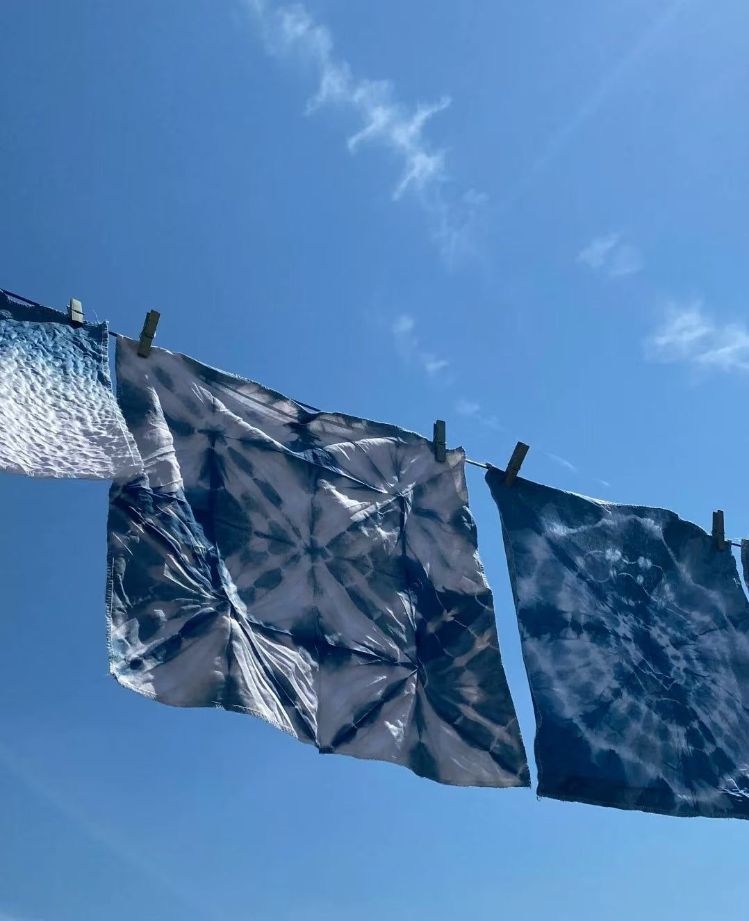 Authentic Japanese gifts for any occasion featuring traditional indigo tie-dye fabric hanging on a clothesline