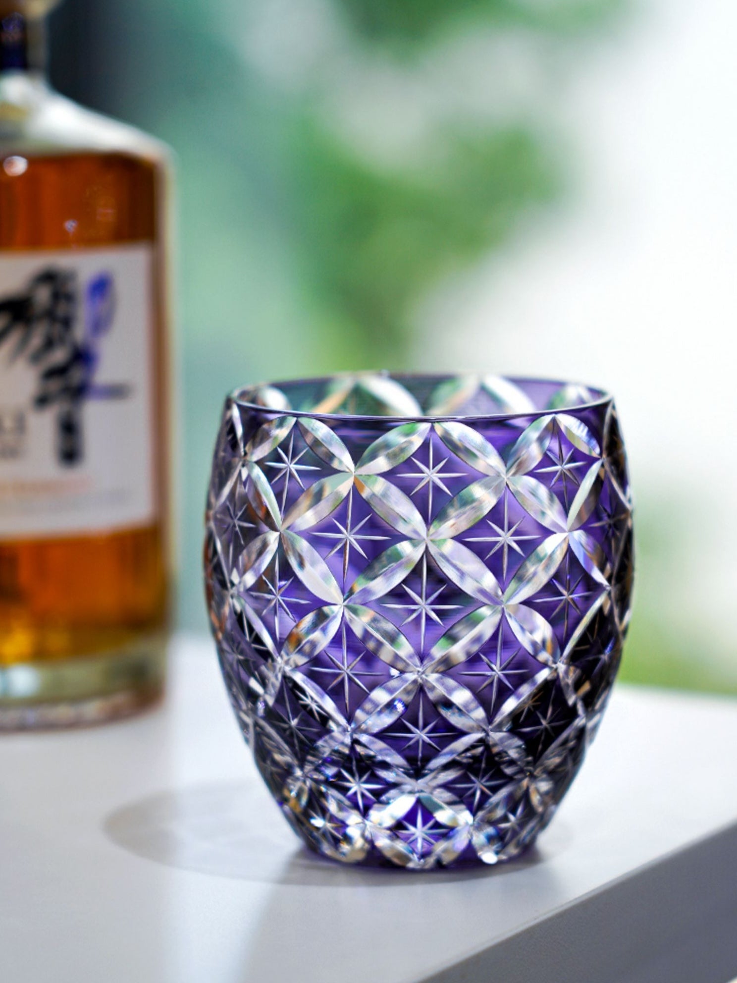 Rin Essense purple cut crystal whiskey glass with intricate geometric starburst pattern for neat pours