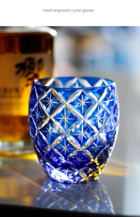 Rin Essense blue hand engraved cut crystal whiskey glass with star pattern on reflective table
