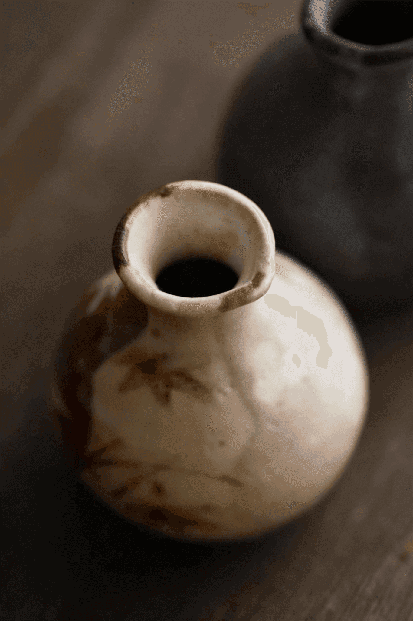 Rin Essense ceramic sake cup with rustic brown and beige glaze on wooden surface