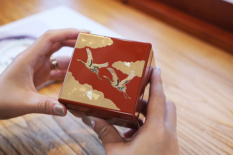 Japanese lacquerware jewelry box by Rin Essense red lacquer with gold cranes held in hands