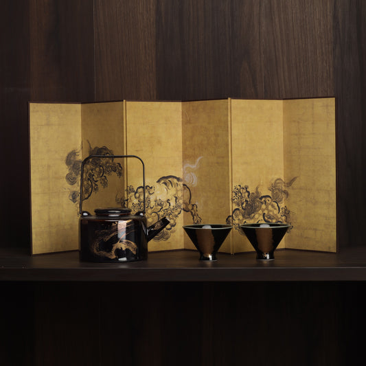 Washi shoji folding screen gold leaf panel behind Rin Essense black lacquer teapot and two matching tea cups