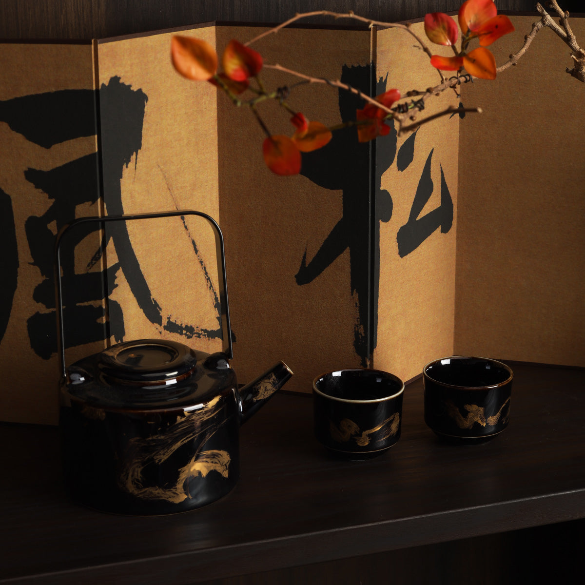 Rin Essense black lacquer tea kettle and two cups displayed before a washi shoji folding screen with autumn branch