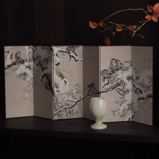Rin Essense Japanese snow scene folding screen displaying six panel ink plum tree painting with ceramic cup and branch