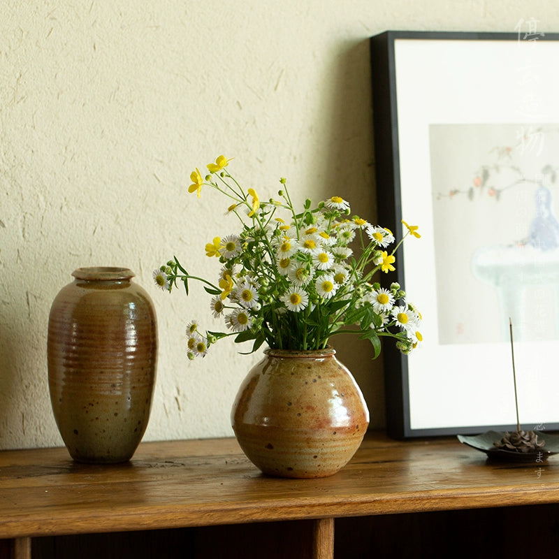 Mini flower vase Japanese decor with fresh white and yellow daisies on wooden shelf