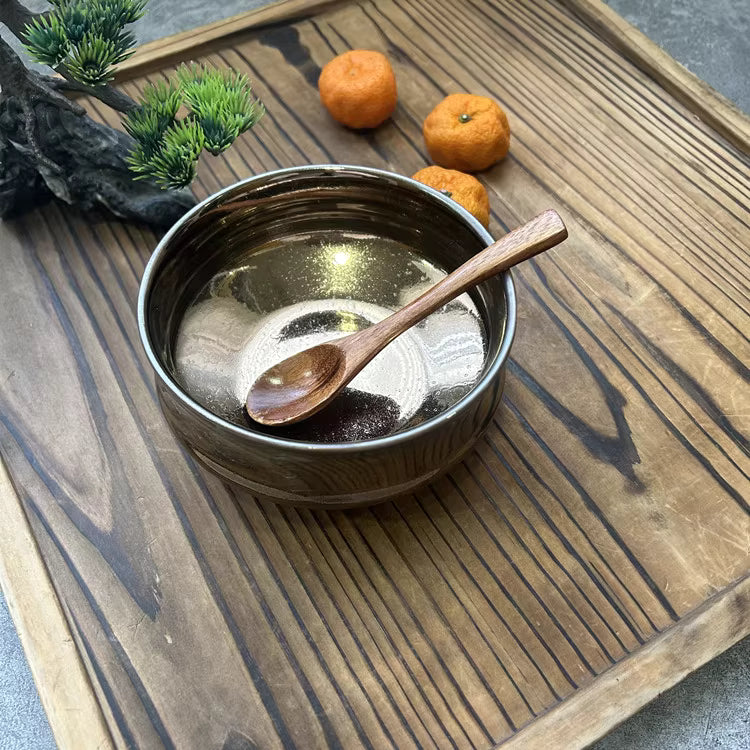 Rin Essense wooden tray with ceramic bowl and wooden spoon displayed with small oranges and green plant decor