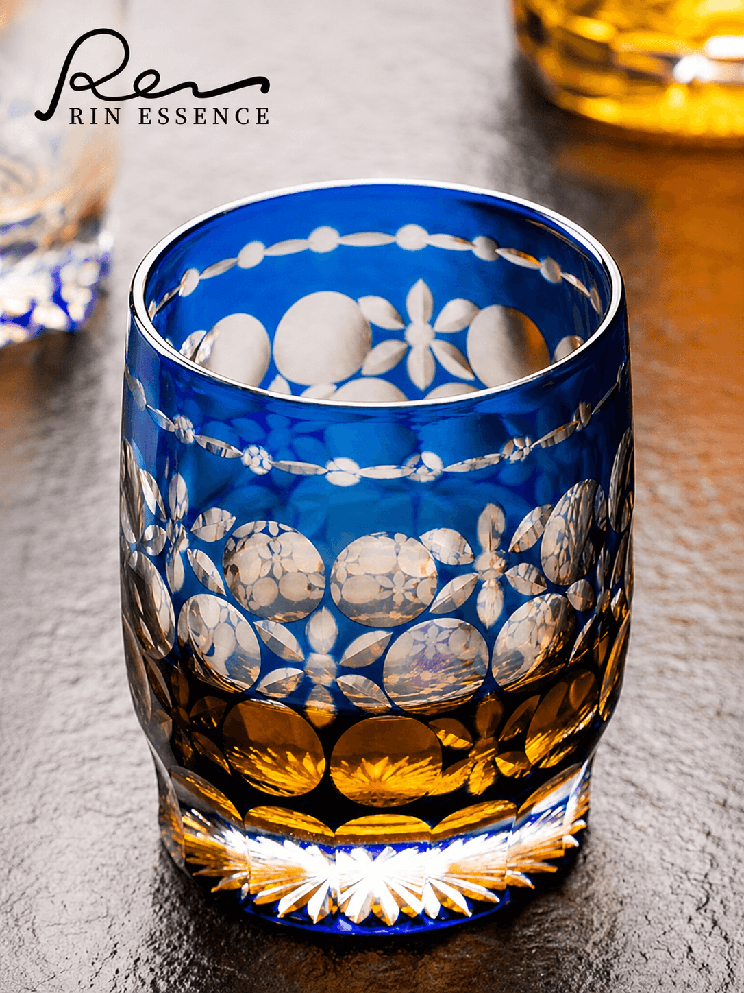 RIN ESSENCE blue and amber glass whiskey with intricate floral and circular patterns