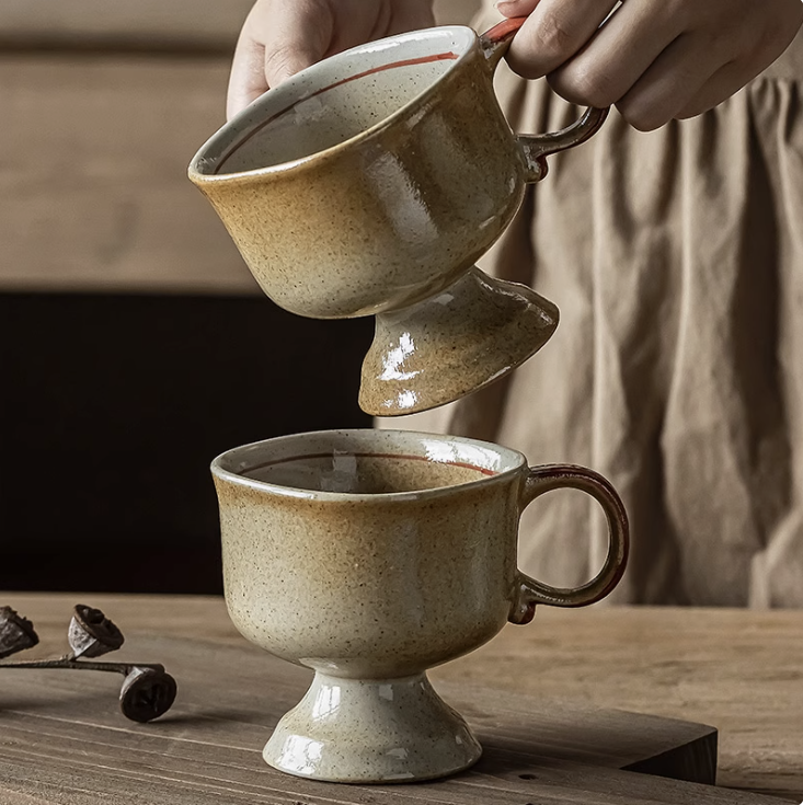 Japanese vintage ceramic cup pair footed beige speckled mugs on wooden table held by hands