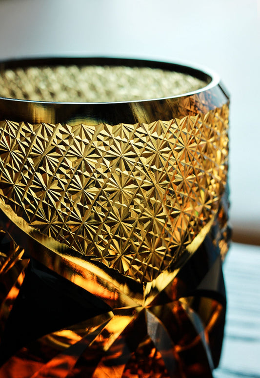 Rin Essense Satsuma Kiriko whiskey glass close up amber cut glass with intricate starburst and geometric patterns
