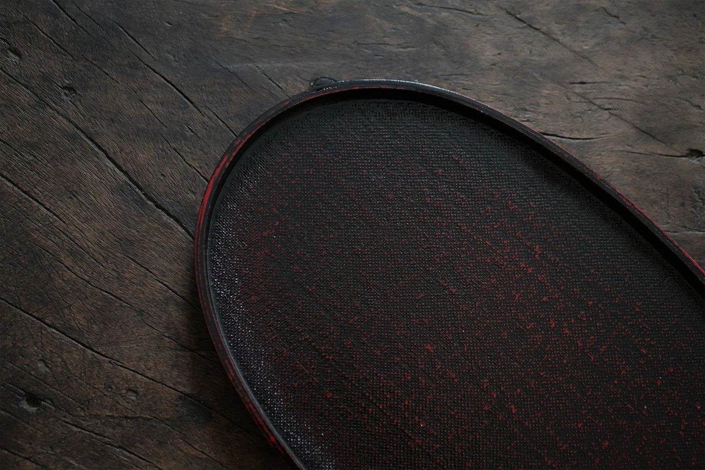 Rin Essense dark wooden tea tray with textured surface on rustic wooden background