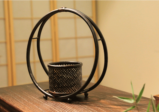 Rin Essense black metal circular candle holder with intricate lattice design for home décor