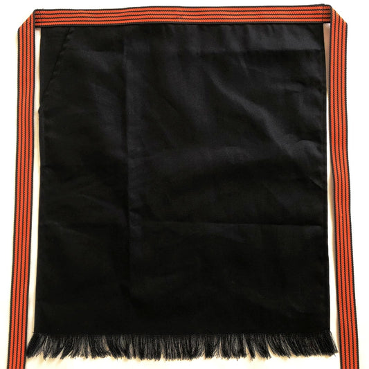 Rin Essense custom Japanese apron with pattern in black featuring orange striped waist ties and fringe hem