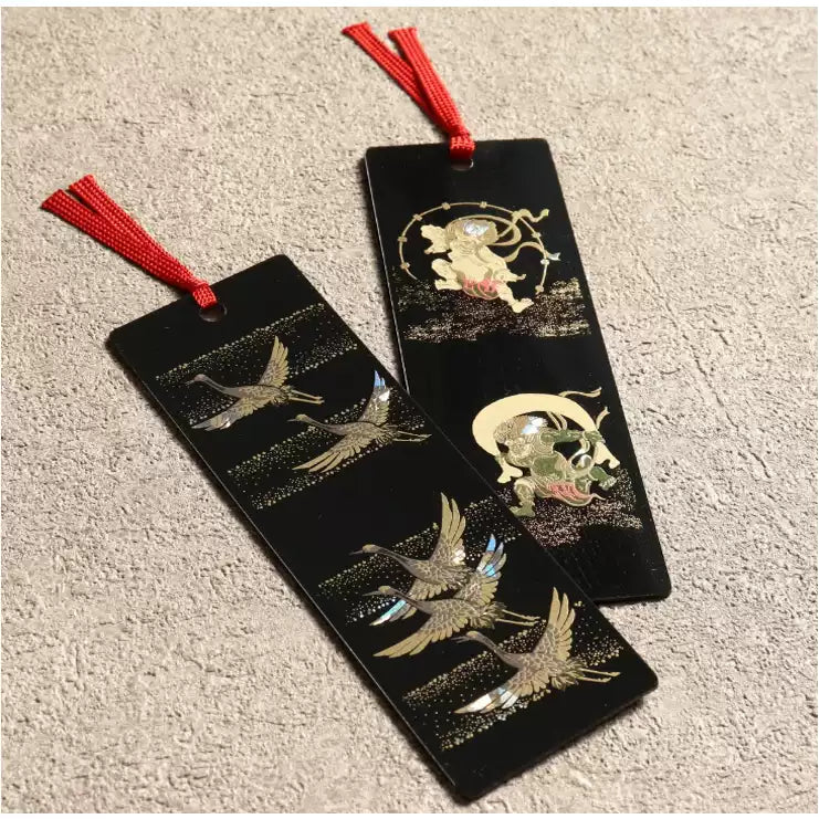 Pair of black handcrafted lacquerware bookmarks with red tassels and gold crane and moon inlay