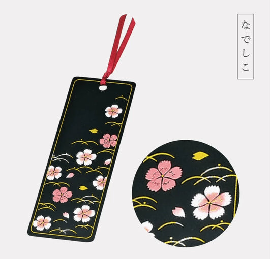 Rin Essense handcrafted lacquerware bookmarks black rectangular sakura design with gold accents and red ribbon close up