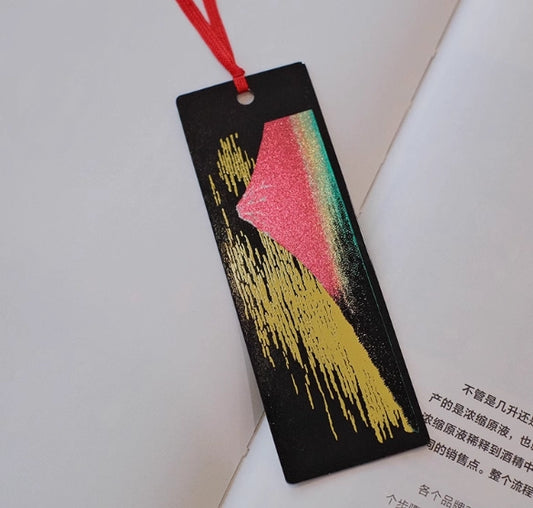 handcrafted lacquerware bookmarks black rectangular bookmark with gold brushstrokes pink green mountain and red ribbon on open book