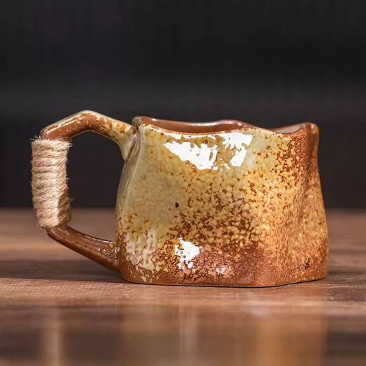 Rin Essense handmade stoneware coffee mug with rustic brown speckled glaze irregular rim and twine wrapped handle