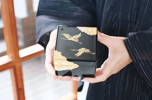Rin Essense Japanese lacquerware jewelry box black with gold crane design held in hands elegant gift