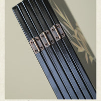 Rin Essense black lacquer table screen with bronze alloy hinges folded to show glossy finish and panel details