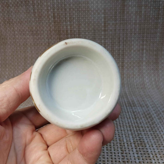 Rin Essense white ceramic sake cup from traditional sake set held in hand