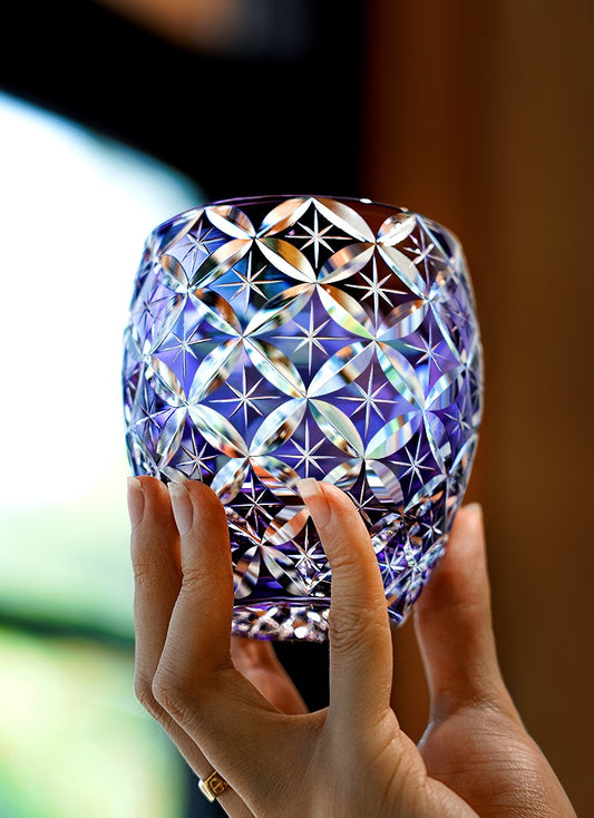 Rin Essense whiskey glass cut crystal tumbler with purple hue held by hand for elegant sipping