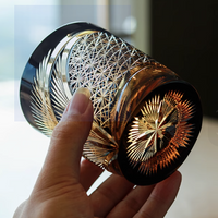 Rin Essense Japanese retro whisky glass cut crystal tumbler held in hand with intricate starburst and lattice patterns