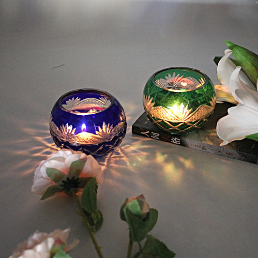 Japanese Edo Kiriko Glass Candle Holder – Round Ball Design in blue and green with intricate floral patterns glowing softly