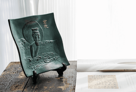 Japanese ironware plate for display home decor featuring intricate design on a wooden table stand