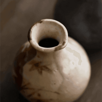 Rin Essense ceramic sake cup with rustic brown and beige glaze on wooden surface