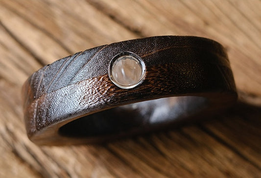 Rin Essense japanese vase with dark wood texture and circular glass detail on wooden surface