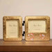 Rin Essense gold-tone double hinged decorative photo frame with floral accents on wooden surface