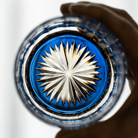 RIN ESSENCE glass whiskey with intricate starburst design viewed from top held in hand