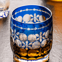 RIN ESSENCE blue and amber glass whiskey with intricate floral and circular patterns