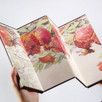 Rin Essense decorative room divider folding screen with colorful pomegranate design held in hands