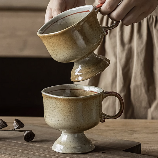 Japanese vintage ceramic cup pair footed beige speckled mugs on wooden table held by hands