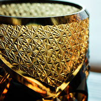Rin Essense Satsuma Kiriko whiskey glass close up amber cut glass with intricate starburst and geometric patterns