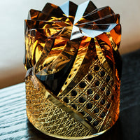 Satsuma Kiriko whiskey glass by Rin Essense amber cut crystal tumbler with intricate lattice and star cuts on dark wood