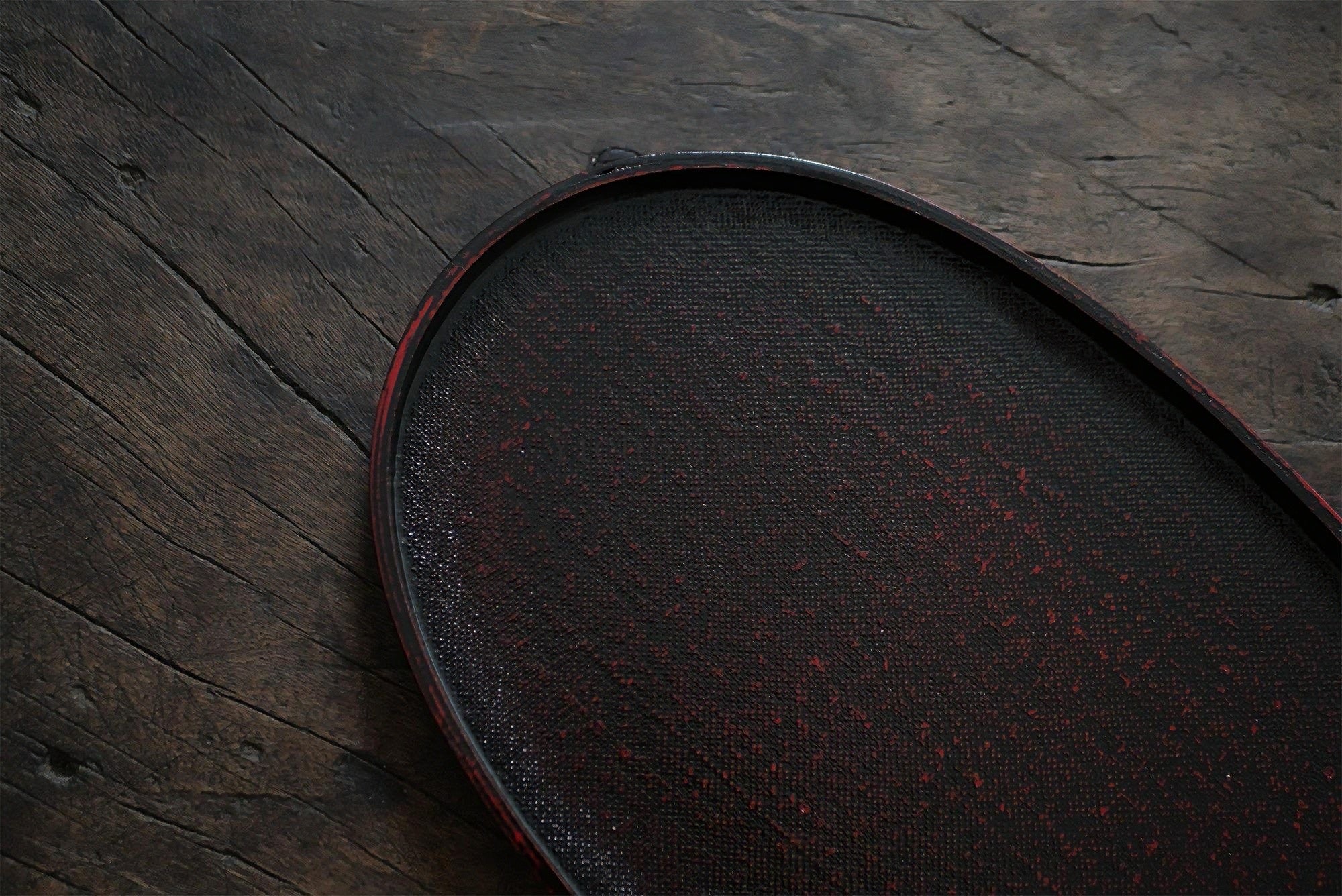 Rin Essense dark wooden tea tray with textured surface on rustic wooden background