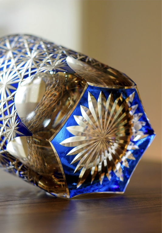 Edo Kiriko whisky glass blue cut crystal with starburst base detail on wooden table