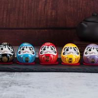 Rin Essense set of five colorful daruma tumbling doll ornament figurines lined on slate for good luck
