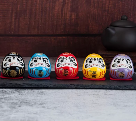 Rin Essense set of five colorful daruma tumbling doll ornament figurines lined on slate for good luck