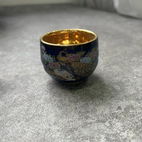 Rin Essense sake cup featuring traditional Japanese ceramic drinkware with floral and peacock design and gold interior