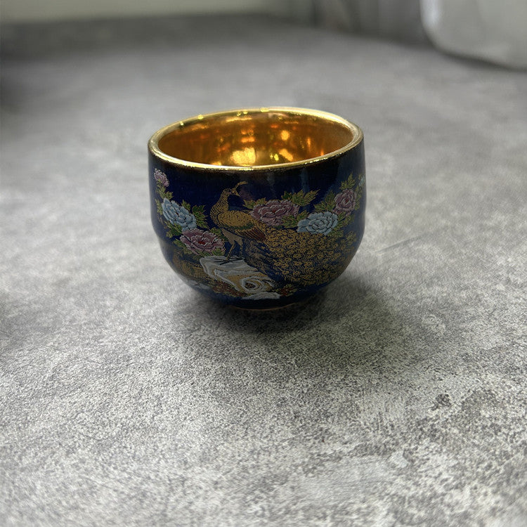 Rin Essense sake cup featuring traditional Japanese ceramic drinkware with floral and peacock design and gold interior