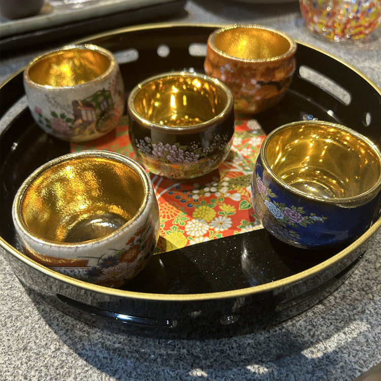 Rin Essense sake cup set featuring traditional Japanese ceramic drinkware with gold interior and floral exterior designs