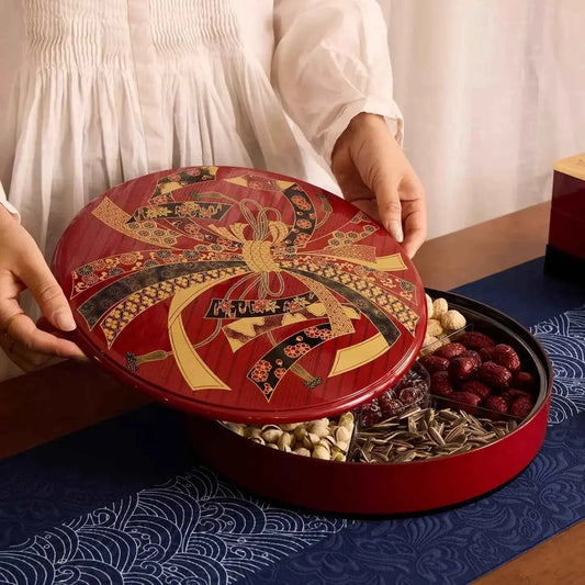 Rin Essense decorative round tray for serving with traditional red and gold design holding assorted snacks