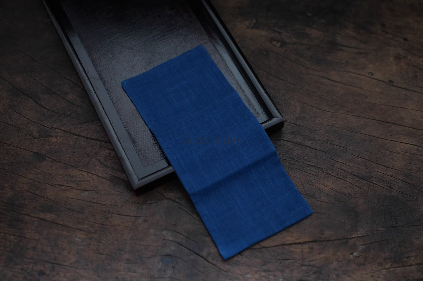 Japanese Indigo Tea Cloth – Hand-Dyed Cotton Linen in deep blue laid on dark wooden tray by Rin Essense