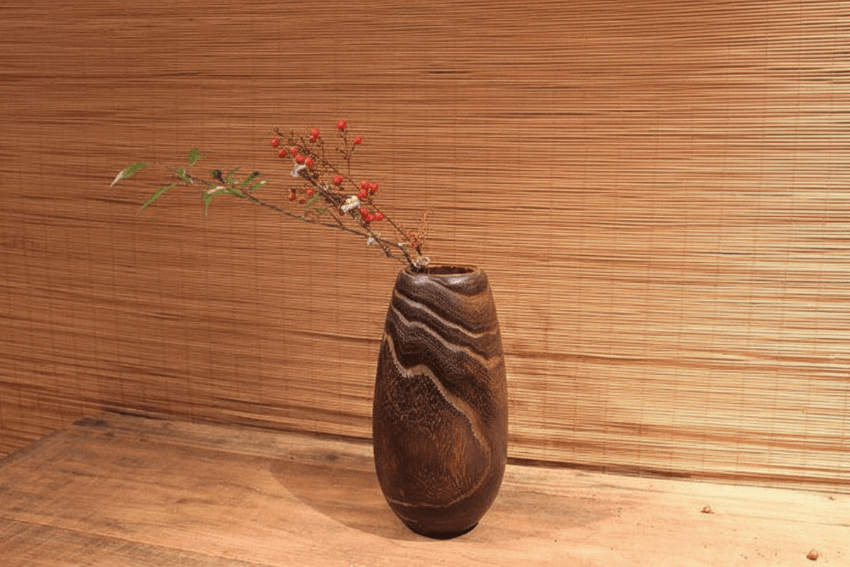 Rin Essense wood vase with natural grain pattern holding delicate red berries and green leaves on wooden surface