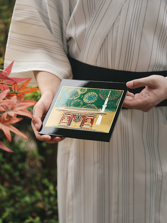 Yamanaka Lacquerware Makie Coaster – Timeless Japanese Craft held by person in traditional kimono outdoors